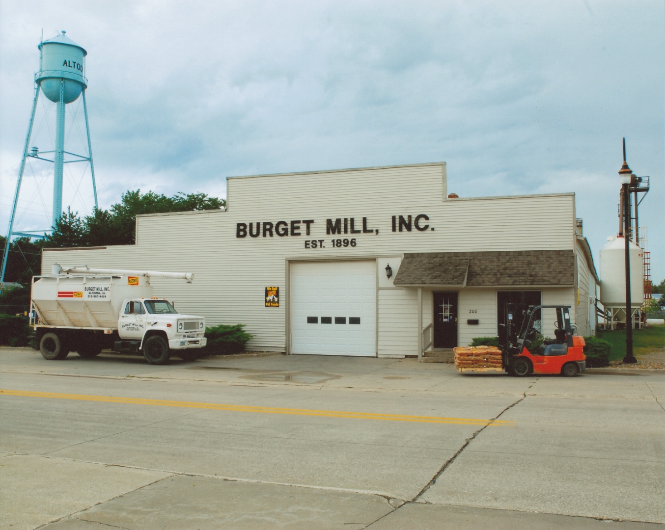 Burget Mill in 2010 with delivery truck, forklift, and Altoona water tower